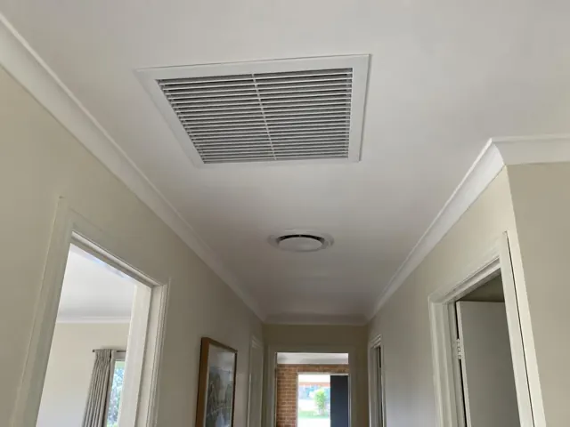 Ceiling return-air grille in a hallway with cream walls and doors in Salisbury Downs